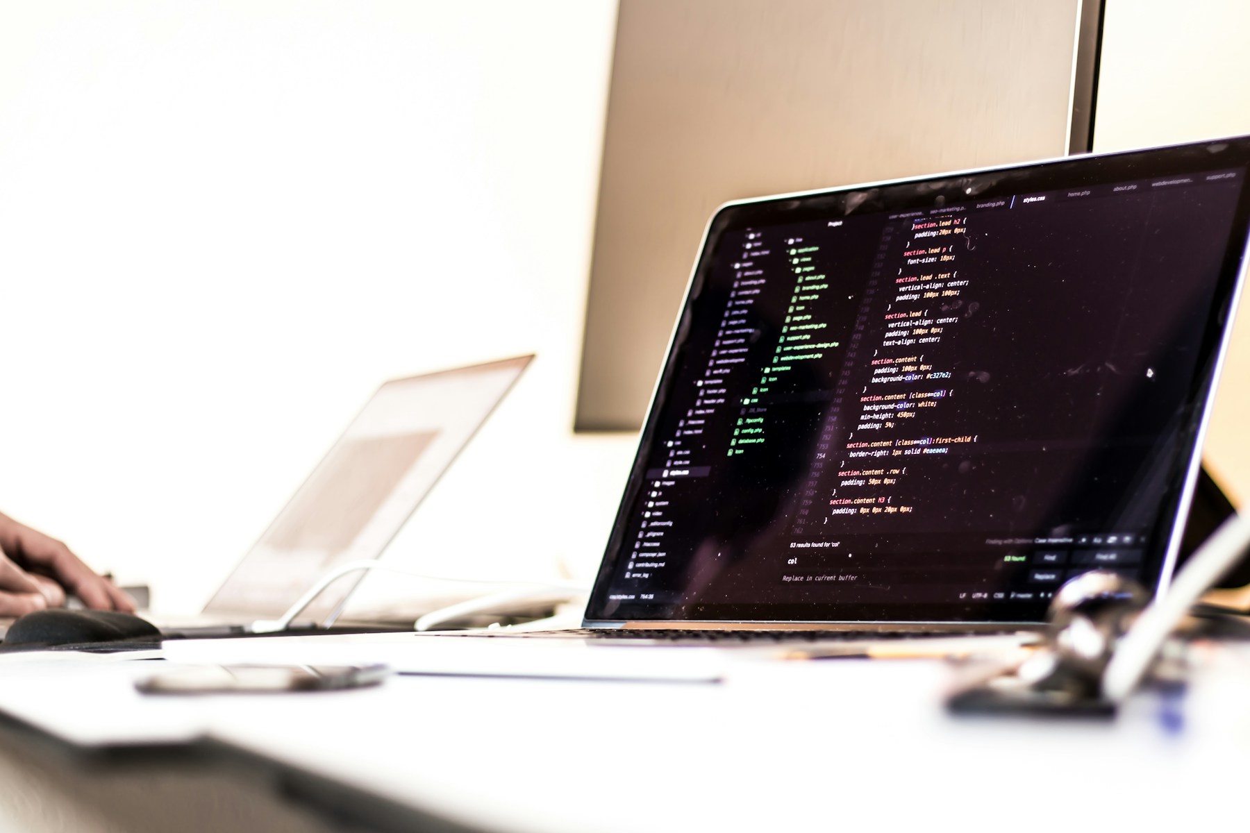 A developer workspace with source code open on a laptop