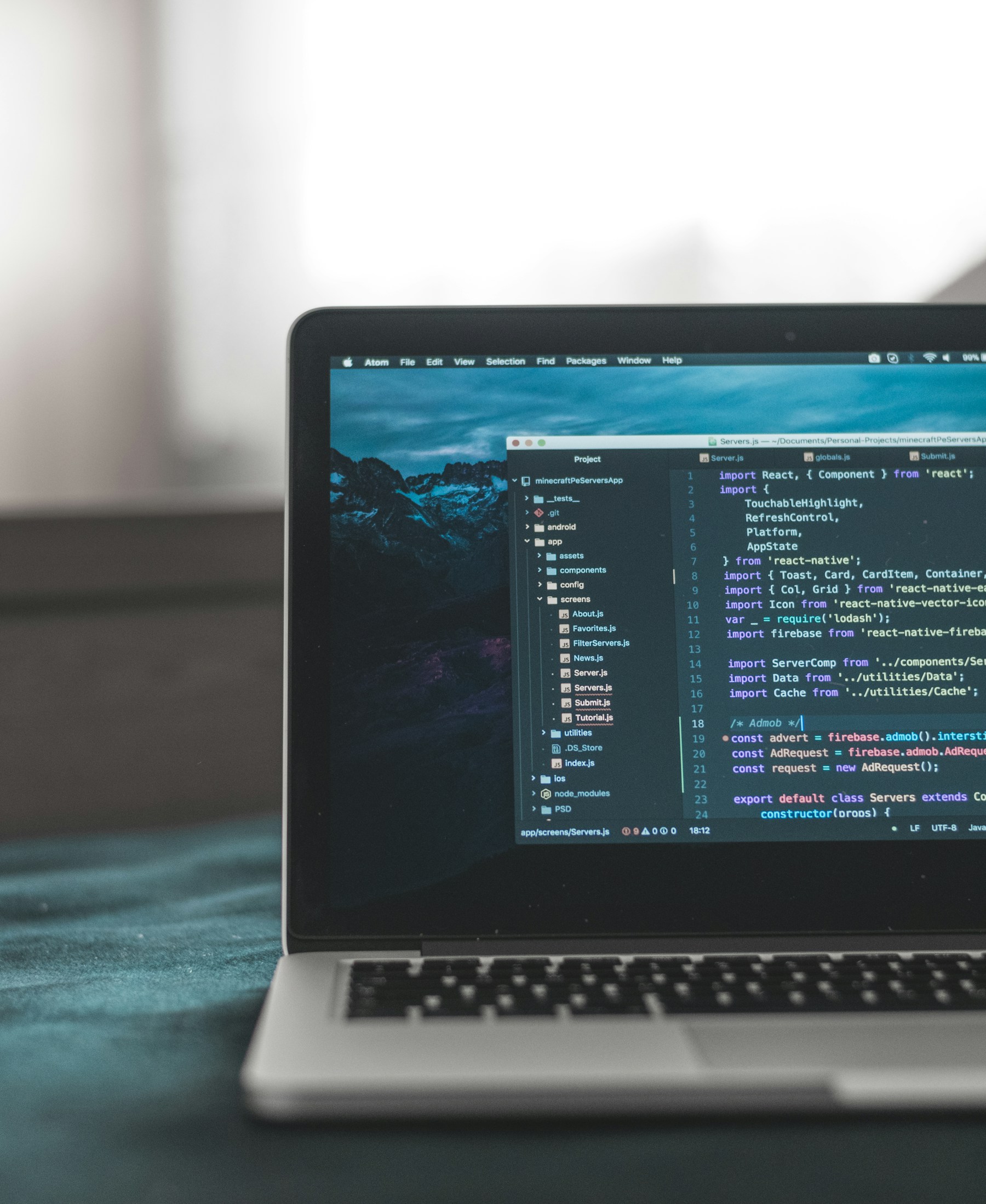Laptop with source code open in a dark workspace
